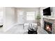 Cozy living room featuring a stone fireplace, neutral decor, and stylish furnishings at 4209 S Bannock St, Englewood, CO 80110