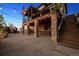 Inviting backyard featuring a covered patio, hot tub, string lights and stone pillars at 14953 Akron Ct, Brighton, CO 80602