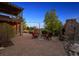 Spacious patio featuring a fireplace and view of upper deck and well manicured garden at 14953 Akron Ct, Brighton, CO 80602