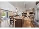 This basement has an open floorplan, kitchen, dining area, multiple televisions, and an outside entrance at 14953 Akron Ct, Brighton, CO 80602