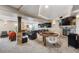 Spacious basement with a stone fireplace, seating, and a game table that's perfect for relaxing and entertaining at 14953 Akron Ct, Brighton, CO 80602