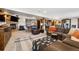 Open basement features seating, a stone fireplace, and a wet bar that's perfect for relaxing and entertaining at 14953 Akron Ct, Brighton, CO 80602