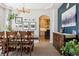 Bright dining room with modern chandelier, adjacent to the kitchen through an arched doorway at 14953 Akron Ct, Brighton, CO 80602