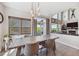 Bright dining room with large windows, stylish curtains, and a modern farmhouse dining table at 14953 Akron Ct, Brighton, CO 80602