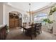 Dining room showcasing a large wood table, arched window, and decorative barn doors at 14953 Akron Ct, Brighton, CO 80602