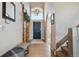 Inviting entryway featuring high ceilings, a modern light fixture and wood accents at 14953 Akron Ct, Brighton, CO 80602