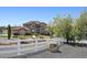 Sprawling home exterior featuring a white fence and mature trees, offering privacy at 14953 Akron Ct, Brighton, CO 80602
