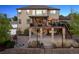 Beautiful home exterior with a deck, stone pillars, string lights, patio and landscape at 14953 Akron Ct, Brighton, CO 80602
