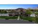 Charming home exterior with manicured lawn, mature trees, and inviting front entrance at 14953 Akron Ct, Brighton, CO 80602