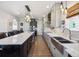 Spacious kitchen with a large island, pendant lights, stainless steel appliances, and wood floors at 14953 Akron Ct, Brighton, CO 80602