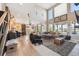 Open-concept living area with high ceilings and expansive windows for abundant natural light at 14953 Akron Ct, Brighton, CO 80602