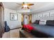 This main bedroom features a ceiling fan, ensuite bathroom, artwork, and a black leather bench at 14953 Akron Ct, Brighton, CO 80602