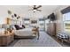 Main bedroom with high ceilings, natural light, stylish decor, and wood furniture at 14953 Akron Ct, Brighton, CO 80602