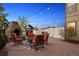 Charming outdoor patio area with fireplace and seating, perfect for relaxation at 14953 Akron Ct, Brighton, CO 80602