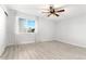 A bright bedroom with a ceiling fan, and a large window with white trim and light colored walls at 580 Vance St # A, Lakewood, CO 80226