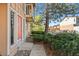 Condo exterior with covered balconies and a mature shade tree near the walkway at 580 Vance St # A, Lakewood, CO 80226