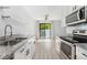 Bright and airy kitchen includes granite countertops, stainless steel appliances, and a view to the dining space at 580 Vance St # A, Lakewood, CO 80226