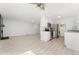 Open-concept living room showcases the kitchen with stainless appliances and a fireplace at 580 Vance St # A, Lakewood, CO 80226