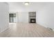 Bright living room features a stone fireplace, light wood floors, and sliding glass doors to the balcony at 580 Vance St # A, Lakewood, CO 80226