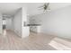 Open-concept space featuring a partial kitchen with granite countertops, with light wood flooring and walls at 580 Vance St # A, Lakewood, CO 80226