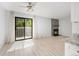 Bright living room featuring light wood floors, a fireplace, and sliding glass doors to a balcony at 580 Vance St # A, Lakewood, CO 80226