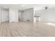 Living room featuring light wood floors and white walls is adjacent to a partial kitchen at 580 Vance St # A, Lakewood, CO 80226