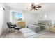 Cozy main bedroom showcases a ceiling fan, a window providing natural light, and neutral decor at 580 Vance St # A, Lakewood, CO 80226
