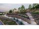 Community outdoor feature with stone walls, steps, landscaping, and pergola at 2011 Grayside Cir, Castle Rock, CO 80109