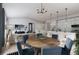Spacious living and dining area with a hardwood table, modern light fixture, and open layout at 2011 Grayside Cir, Castle Rock, CO 80109
