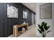 Stylish hallway with wood-paneled walls, modern art, and a minimalist console table at 2011 Grayside Cir, Castle Rock, CO 80109