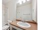 Well-lit bathroom features a tub, toilet, sink, vanity, and a mirror at 4435 Andes Ct, Denver, CO 80249