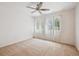Bright bedroom featuring neutral carpeting, ceiling fan, and bright window at 4435 Andes Ct, Denver, CO 80249