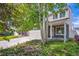 Charming two-story home featuring a stone facade, attached garage, and landscaped front yard with mature trees at 4435 Andes Ct, Denver, CO 80249