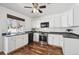 Bright kitchen featuring white cabinets, black appliances, granite countertops, and hardwood floors at 4435 Andes Ct, Denver, CO 80249
