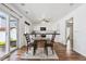 Open kitchen and dining area with white cabinets, black appliances, and hardwood flooring throughout at 4435 Andes Ct, Denver, CO 80249