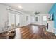 Spacious living room with hardwood floors, a sliding glass door, and a charming electric fireplace at 4435 Andes Ct, Denver, CO 80249