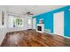 Cozy living room featuring hardwood floors, an electric fireplace, and a ceiling fan with plenty of natural light at 4435 Andes Ct, Denver, CO 80249