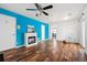 Bright living room with hardwood floors, a modern fireplace, and a ceiling fan for added comfort at 4435 Andes Ct, Denver, CO 80249