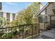 Balcony with views of trees and nearby building at 4802 E Kentucky Ave # E, Denver, CO 80246