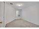 Empty bedroom features neutral carpet, a window with blinds, and a closet for storage at 4802 E Kentucky Ave # E, Denver, CO 80246