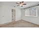 Bright bedroom has neutral carpet, ceiling fan and a window providing lots of natural light at 4802 E Kentucky Ave # E, Denver, CO 80246