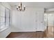 Bright dining area features wood floors, a window with blinds and decorative chandelier at 4802 E Kentucky Ave # E, Denver, CO 80246