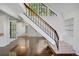 Welcoming entryway with wood floors, staircase, and large windows providing ample natural light at 4802 E Kentucky Ave # E, Denver, CO 80246