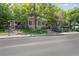 Charming exterior view of home with mature trees, lush landscaping, and well-maintained grounds at 4802 E Kentucky Ave # E, Denver, CO 80246