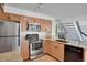 Kitchen with stainless steel appliances, adjacent to the staircase and living room at 4802 E Kentucky Ave # E, Denver, CO 80246