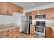 Bright kitchen featuring granite counters, stainless steel appliances, and updated cabinets at 4802 E Kentucky Ave # E, Denver, CO 80246