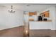 Open living area features wood floors leading to the updated kitchen with granite counters and stainless appliances at 4802 E Kentucky Ave # E, Denver, CO 80246