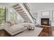 Bright living room featuring a fireplace and staircase, ideal for relaxation at 4802 E Kentucky Ave # E, Denver, CO 80246