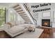 Cozy living room features a fireplace, stairs, and hardwood floors, creating a warm and inviting atmosphere at 4802 E Kentucky Ave # E, Denver, CO 80246