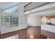 Bright living room with large windows, hardwood floors, and a loft overlooking the space at 4802 E Kentucky Ave # E, Denver, CO 80246